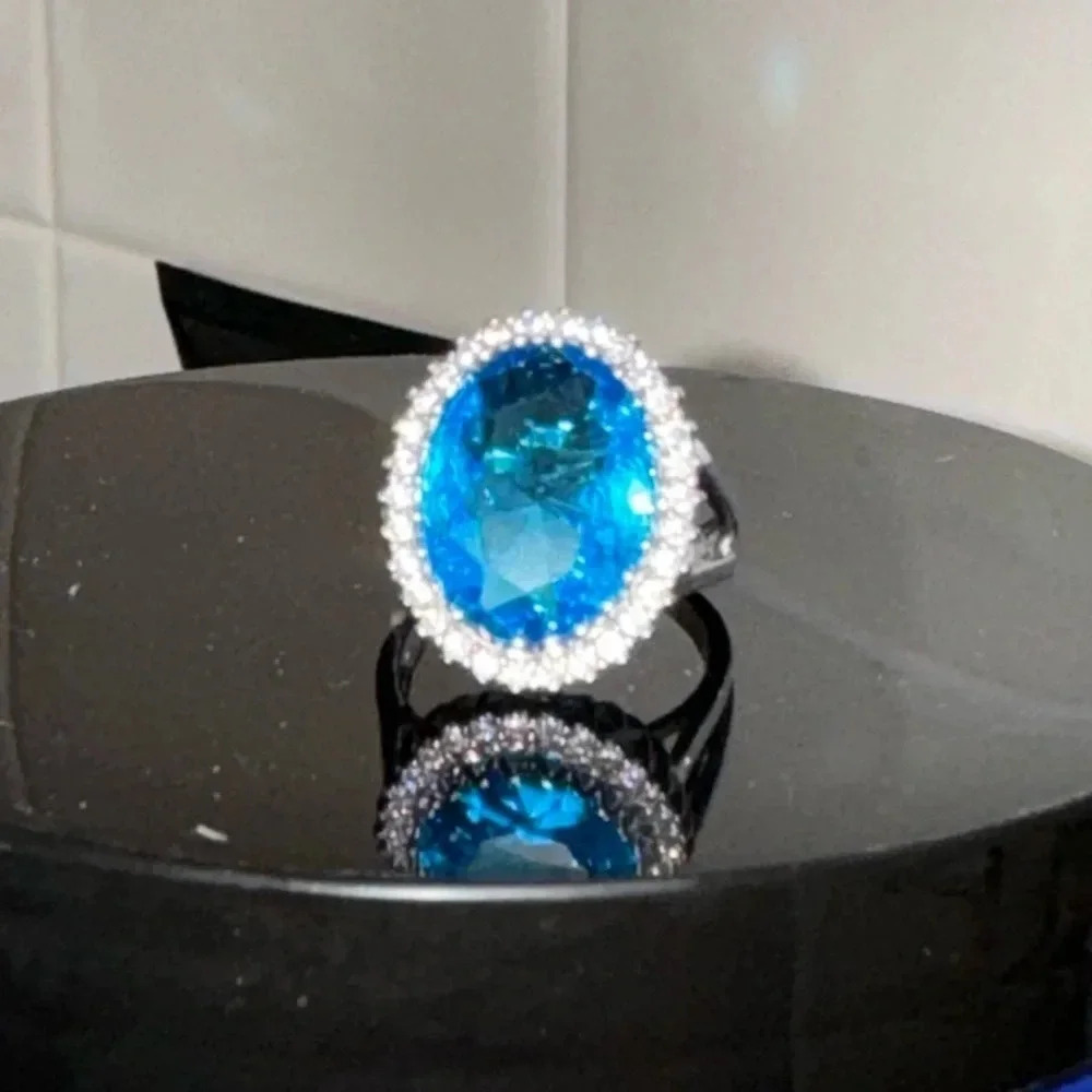 London blue topaz oval with a clear rhinestone halo set in a 925 split shank 7